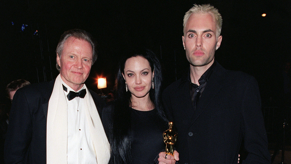 Jon Voight smiles next to Angelina Jolie and James Haven 