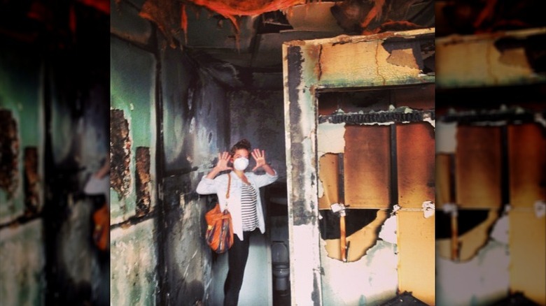 Annie Murphy inside burned down house
