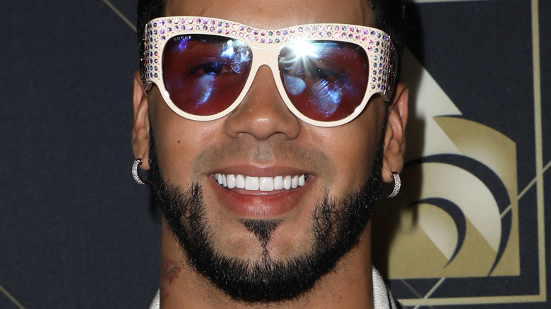 Anuel AA wearing glasses on the red carpet