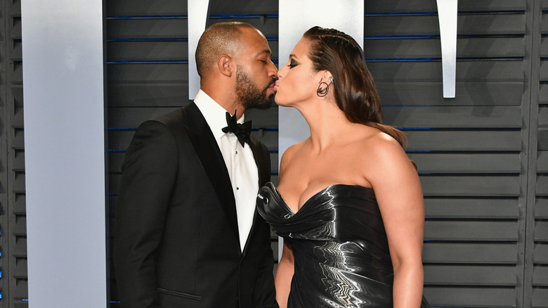 Justin Ervin and Ashley Graham kiss at event