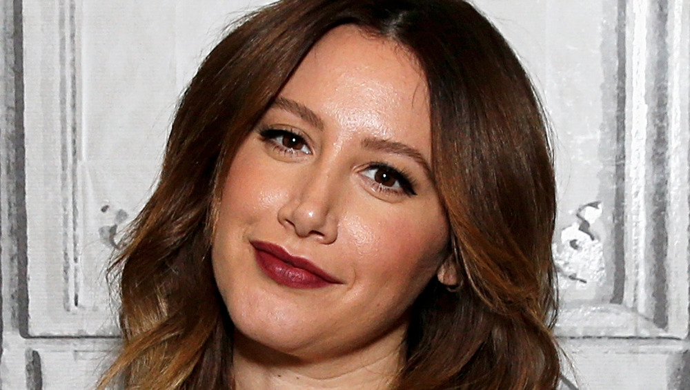 Ashley Tisdale wears an animal-print dress at an event