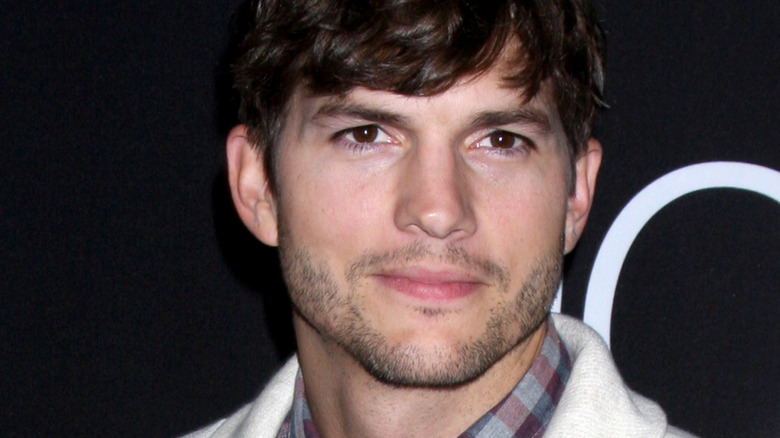 Ashton Kutcher looks on