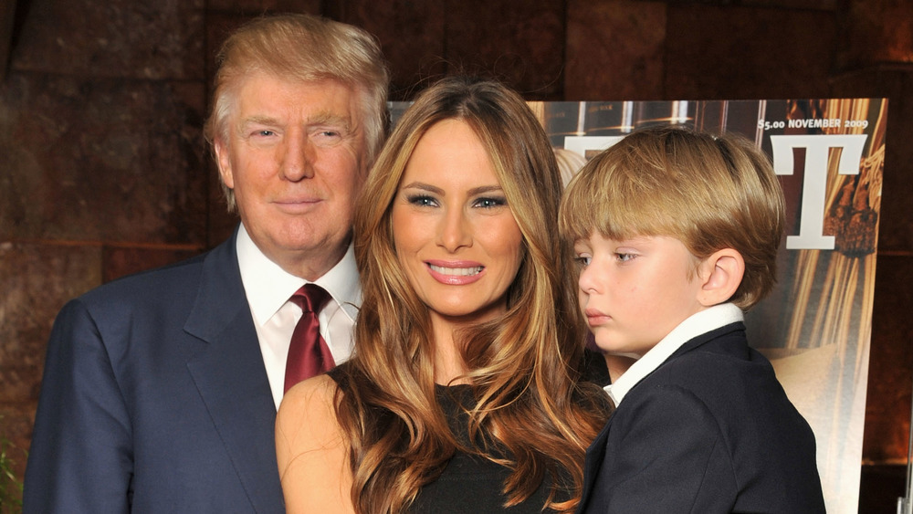 Donald Trump and Melania Trump posing with Barron Trump