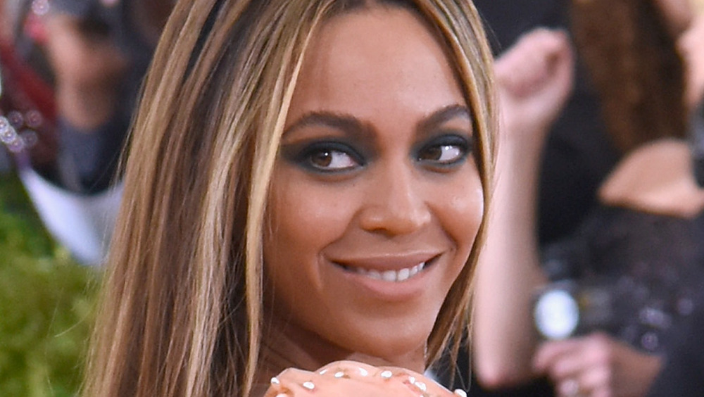 Beyoncé poses in a peach dress.