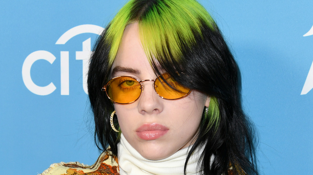 Billie Eilish wearing orange glasses