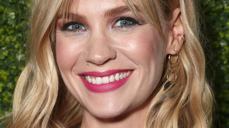 January Jones smiles wearing pink lipstick