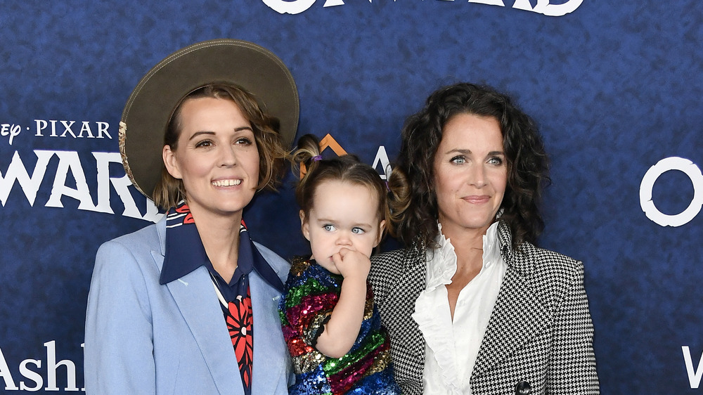 Brandi Carlile and Catherine Shepherd pose with their daughter.