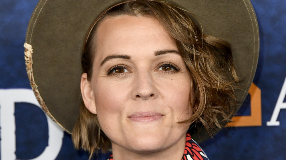 Brandi Carlile poses in a felt hat.