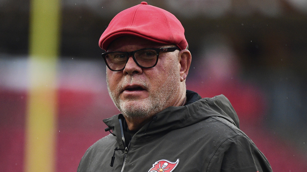 Bruce Arians in black rimmed glasses looks into the camera