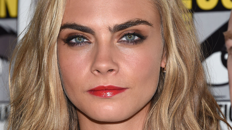 Slight smile Cara Delevingne blonde hair