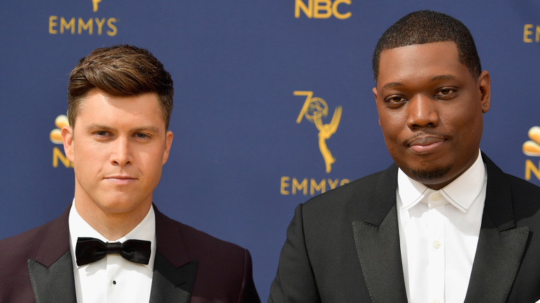 Colin Jost and Michael Che standing together