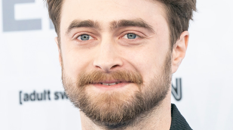 Daniel Radcliffe smiles in sweater