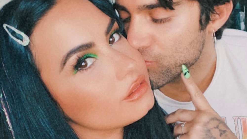 Demi Lovato getting a kiss from Max Ehrich in an Instagram selfie