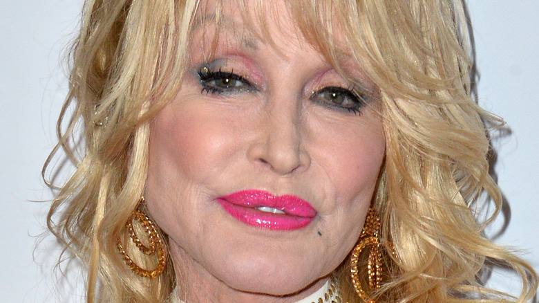 Dolly Parton smiles on the red carpet