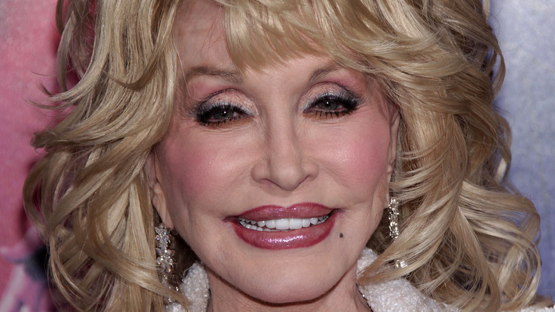 Dolly Parton smiling and looking at camera