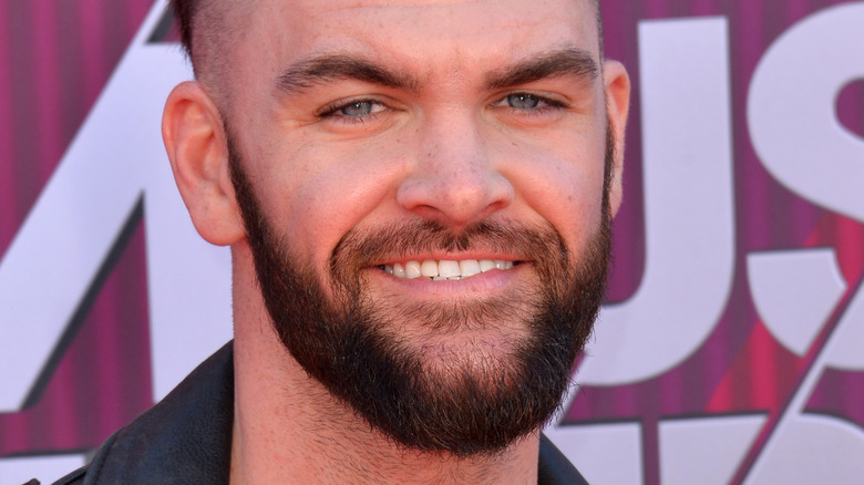 Dylan Scott smiles on the red carpet