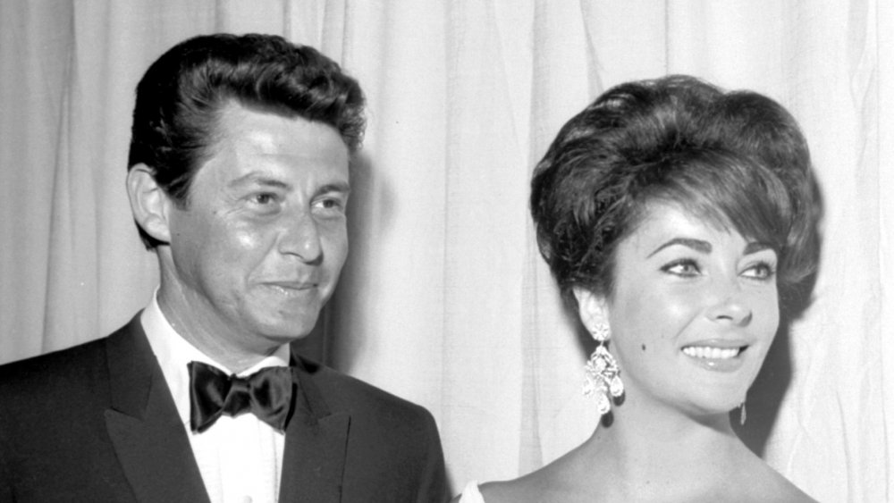 Actress Elizabeth Taylor attends an event with her husband entertainer Eddie Fisher in circa 1960.