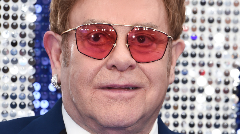 Elton John smiles at a photo call