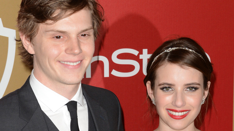 Evan Peters, Emma Roberts, both smiling