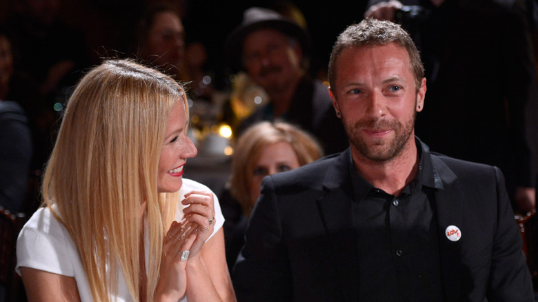 Gwyneth Paltrow claps for Chris Martin at an event