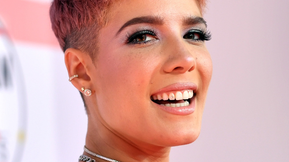 Halsey smiling with a jewel on her tooth