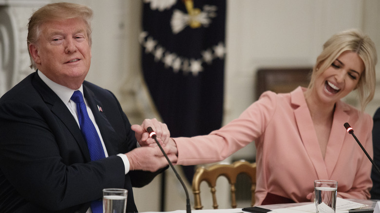 Donald Trump and Ivanka Trump laughing and shaking hands during a meeting