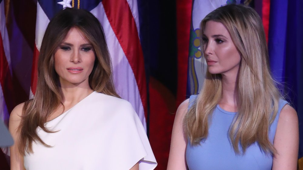 Melania Trump in a white dress, Ivanka Trump in a blue dress