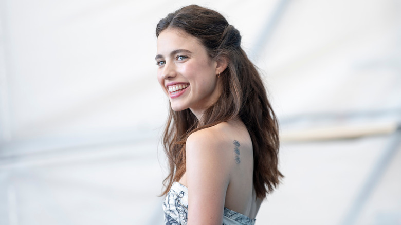 Margaret Qualley with wide smile on the red carpet
