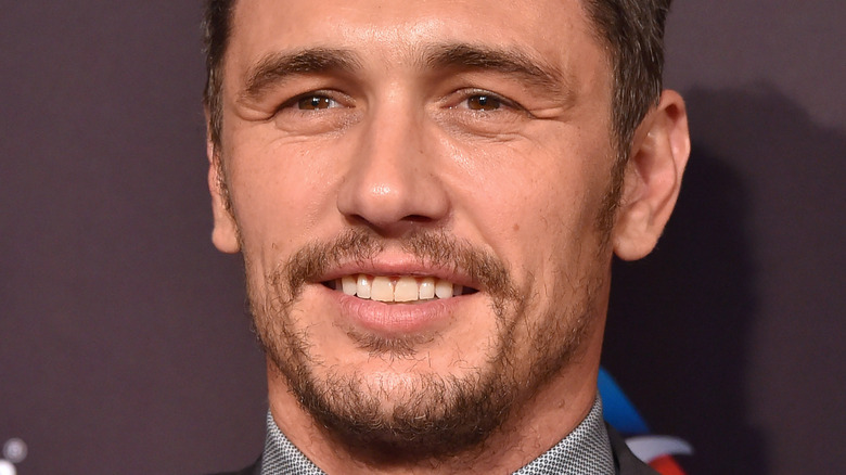 James Franco slightly smiling and looking to side on red carpet 