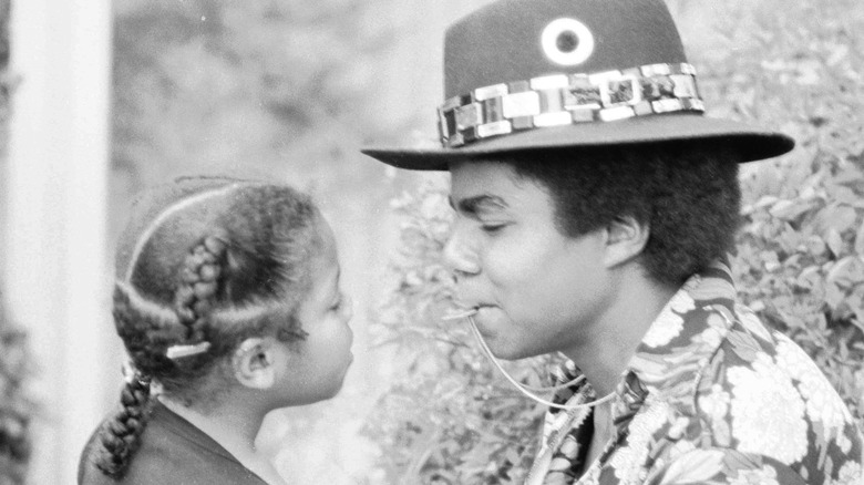 Young Janet and Tito Jackson looking at one another
