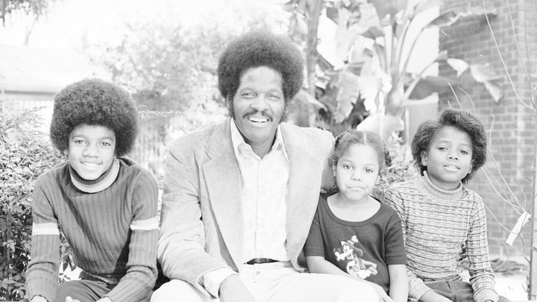 A young Janet Jackson with family, all seated
