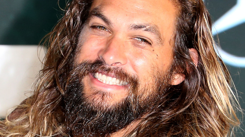 Jason Momoa head cocked on red carpet