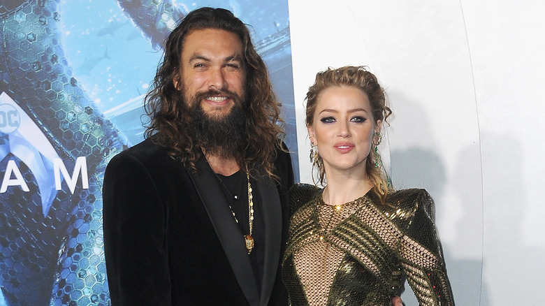 Amber Heard and Jason Momoa posing
