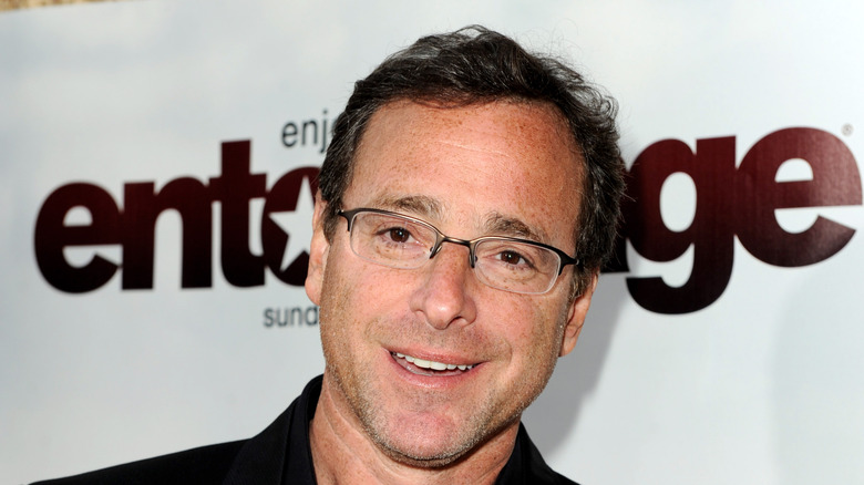 Bob Saget in front of Entourage sign