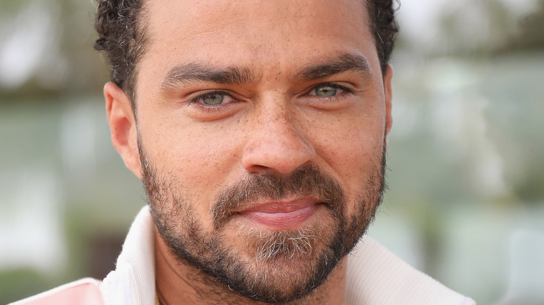 Jesse Williams smiles at an event