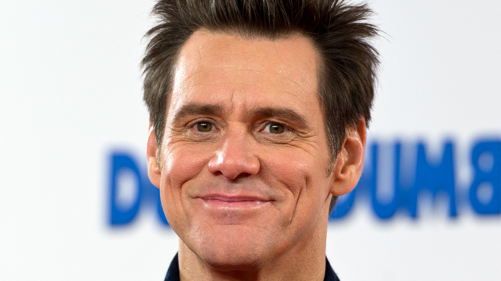 Jim Carrey smiles on the red carpet for Dumber and Dumber To in 2014