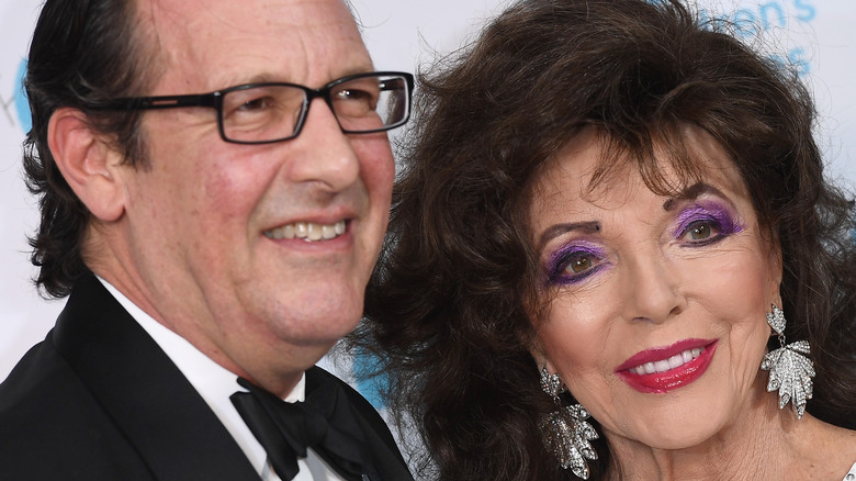 Percy Gibson and Joan Collins posing on the red carpet