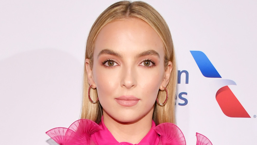 Jodie Comer smiling slightly