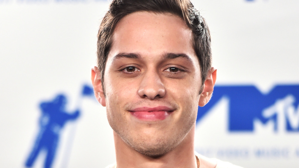 Pete Davidson smirking