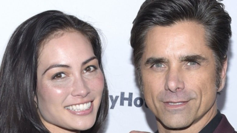 Caitlin McHugh and John Stamos attend Bob Saget's Cool Comedy Hot Cuisine in 2019