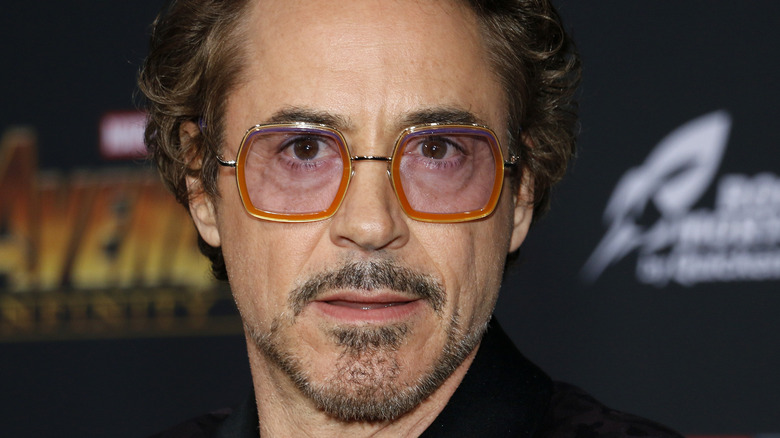 Robert Downey Jr. wearing glasses half smile to camera