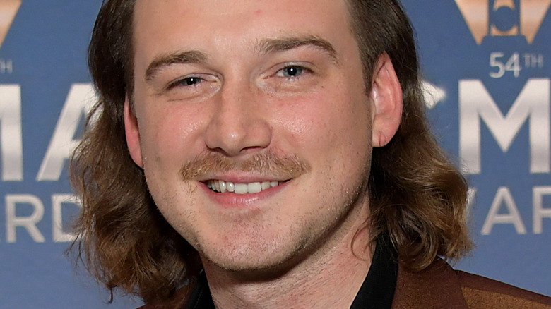 Morgan Wallen smiling on the red carpet