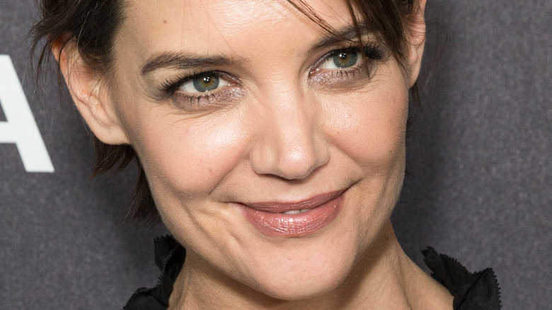 Katie Holmes smiles with hair pulled back