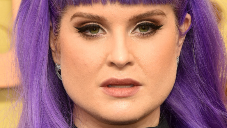Kelly Osbourne with a neutral expression