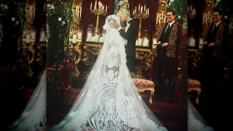 Kourtney Kardashian and Travis Barker kissing at their wedding