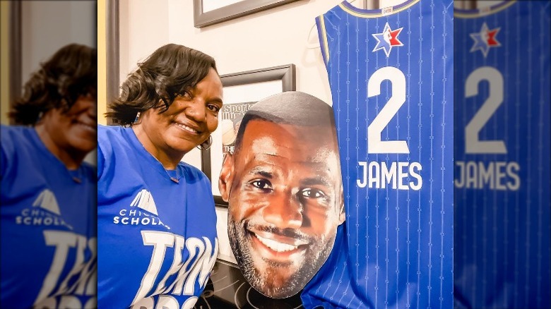 Gloria James posing next to LeBron James's cutout