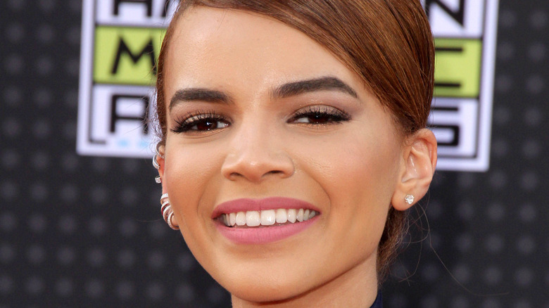 Leslie Grace smiles on the red carpet