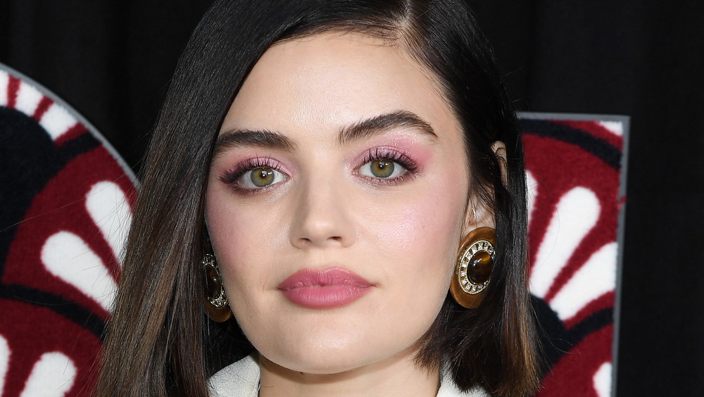 Lucy Hale with bobbed hair and big earrings