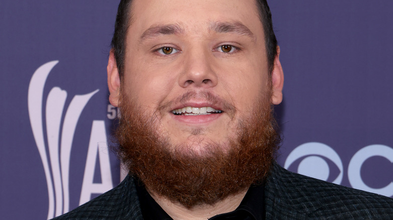 Luke Combs smiling on the red carpet