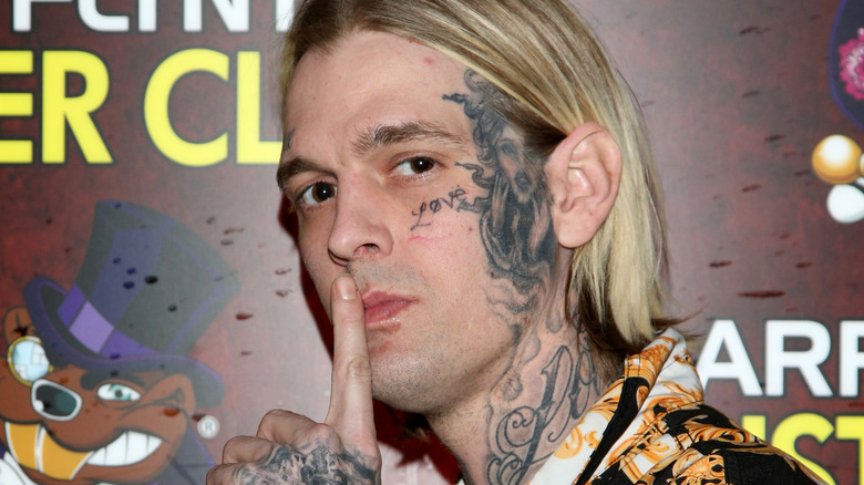 Aaron Carter with finger over lips